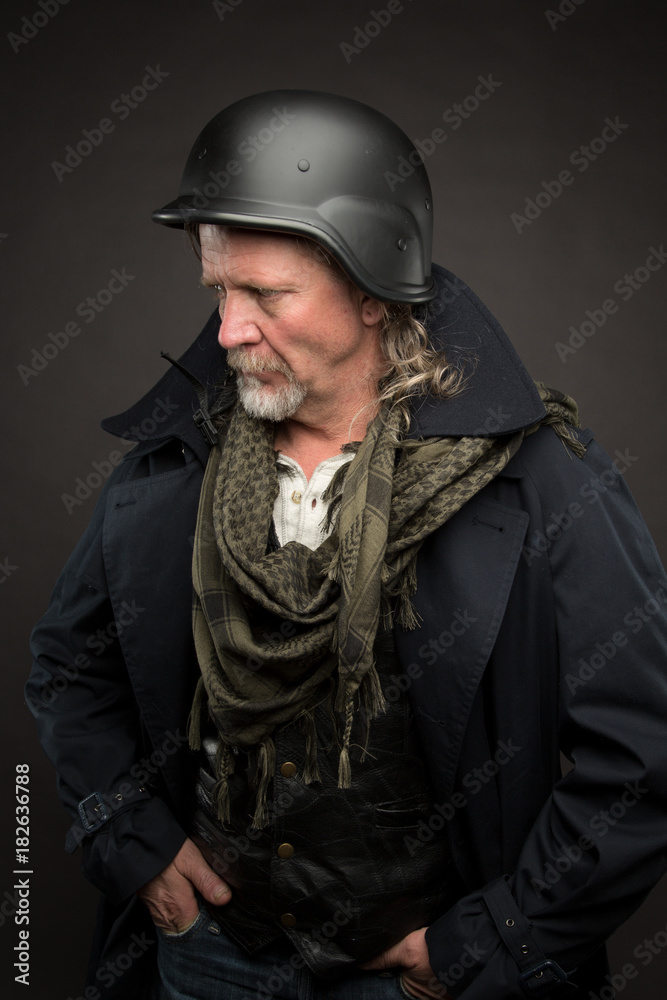 Older man in long coat with helmet. Older man in long coat with helmet.