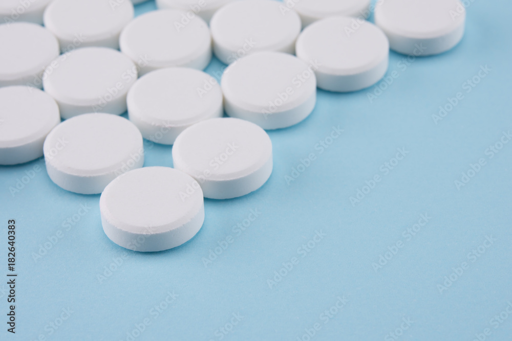white pills on blue background with space for adding text white pills on blue background with space for adding text