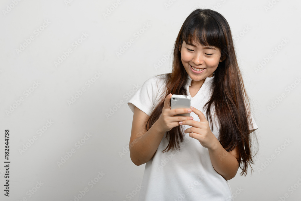 Portrait of beautiful Asian woman against white background Portrait of beautiful Asian woman against white background