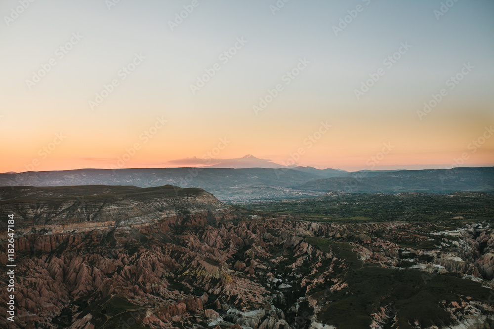 Beautiful view of the hills of Cappadocia. One of the sights of Turkey. Tourism, travel, beautiful landscapes, nature. Morning sunrise. Awesome landscape.