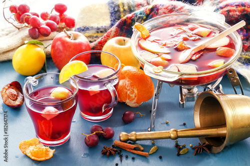 Boil mulled wine and punch. Glass jars with mulled wine. Spices, fruit. Hot wine for winter