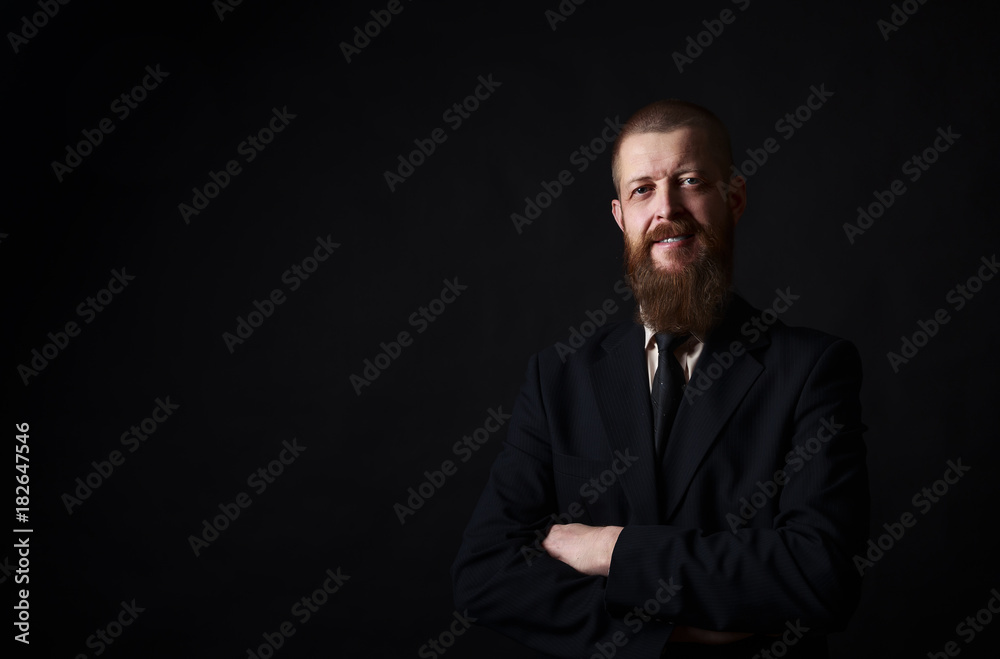 businessman with beard posing in black shirt on dark background in studio. place for copy-paste businessman with beard posing in black shirt on dark background in studio. place for copy-paste