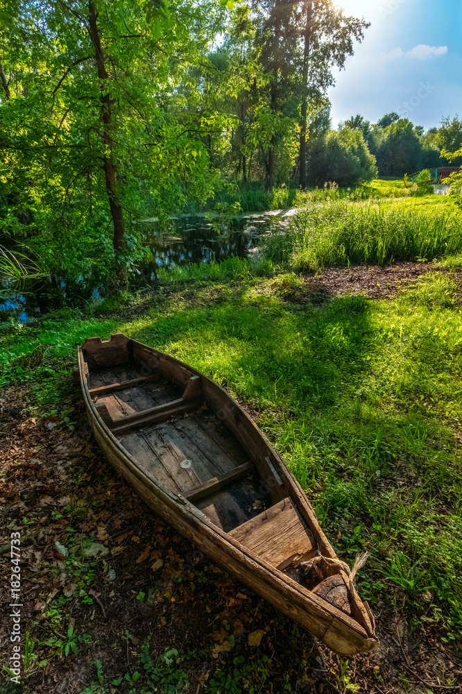 A wooden boat lies on the shore during the day A wooden boat lies on the shore during the day