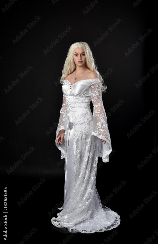 full length portrait of a blonde lady wearing beautiful lace gown, standing pose on black background. full length portrait of a blonde lady wearing beautiful lace gown, standing pose on black background.