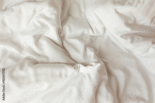 Top view of white bedding sheets after wake up in the morning