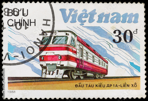 Old vintage postage stamp with soviet locomotive and railway, printed in Vietnam in 1988