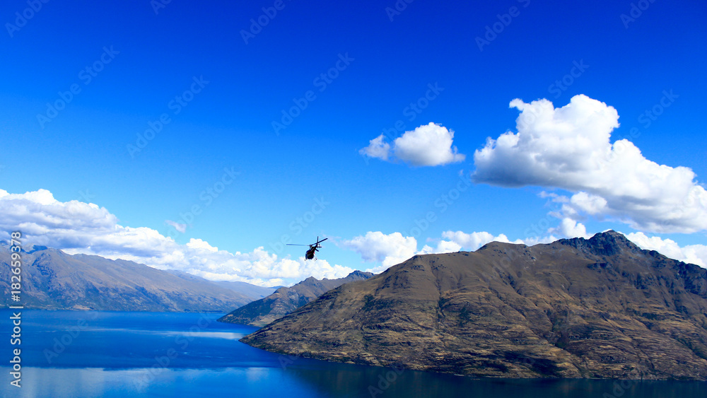 helicopter flying above the mountains and Lake Wakatipu, Queenstown