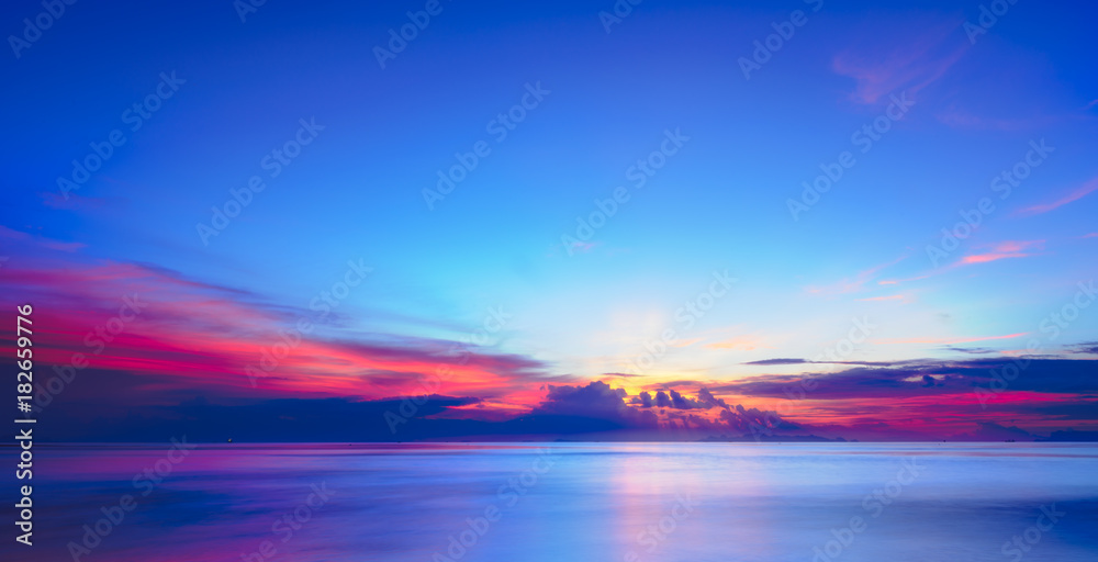 Fototapeta premium Sunset dramatic colorful tropical sea sky and cloud background,Long exposure image