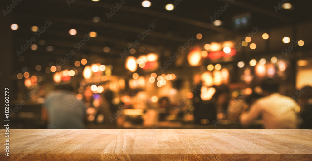 Wood table top (Bar) with blur light bokeh in dark night cafe