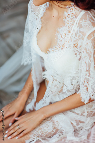 Beautiful bride in lingerie and white dress