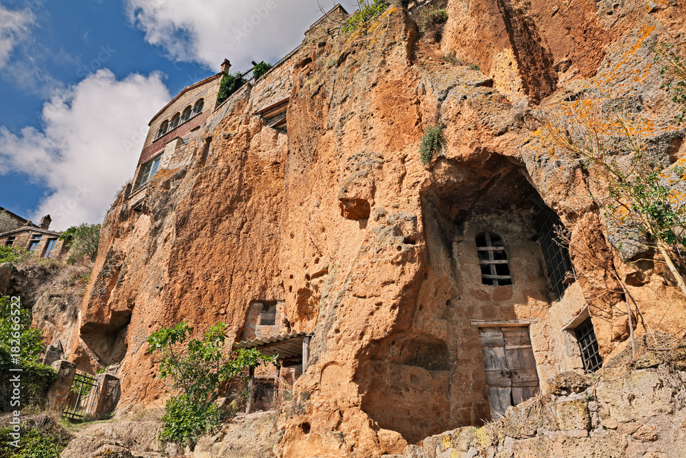 Civita di Bagnoregio, Viterbo, Lazio, Italy: the rock face with caves and rock-cut cellars