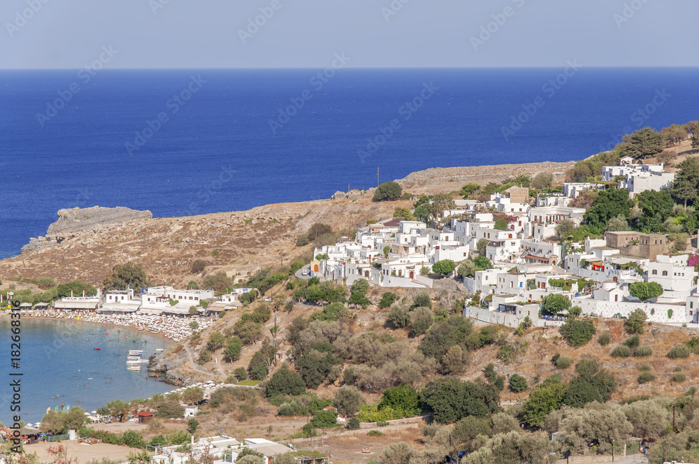 Summer bottom view of Rhodes Acropolis of Lindos with sea
