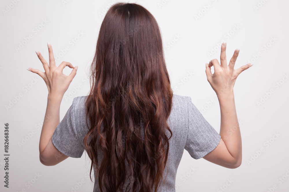 Back view of Asian woman show double OK hand sign. Back view of Asian woman show double OK hand sign.