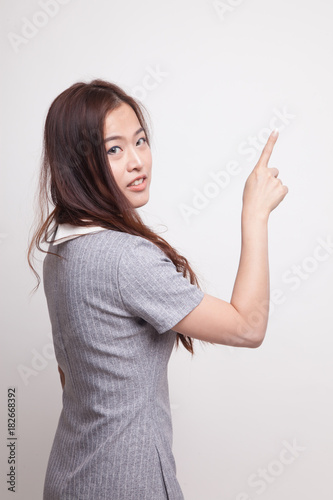 Back of Asian woman touching the screen with her finger.