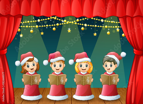 Cartoon children in red santa costume singing christmas carols on the stage