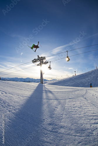 Skier jumping over big kicker in funpark, Betterpark, Kaltenbach, Zillertal, Austria photo