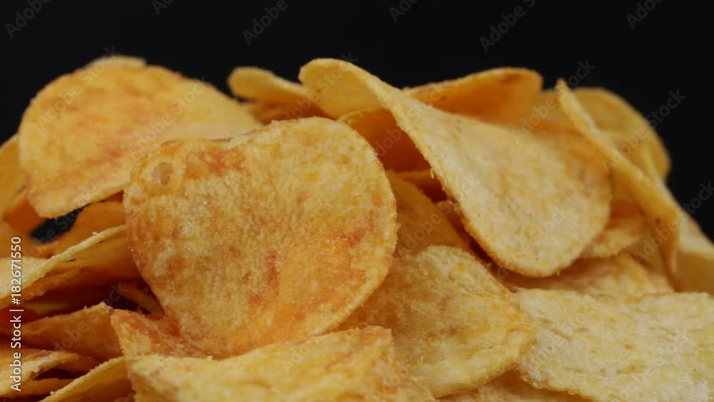 Rotating potato chips close up, macro view food background Rotating potato chips close up, macro view food background
