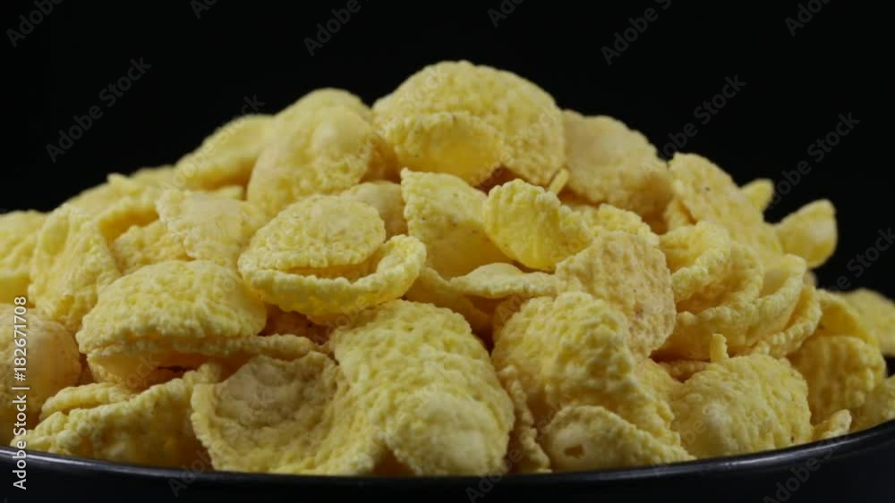 Rotating corn chips close up, macro crunchy corn chips for muesli background Rotating corn chips close up, macro crunchy corn chips for muesli background