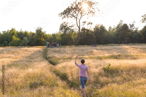 Mother waving to her son (4 years), Marielyst, Falster, Denmark photo