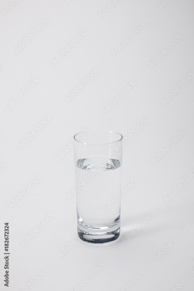 transparent glass with calm water on white transparent glass with calm water on white