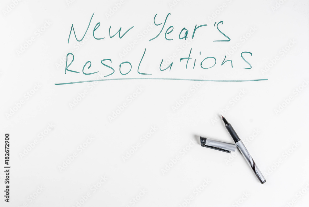 New years resolutions, white board background with pen, copy space New years resolutions, white board background with pen, copy space