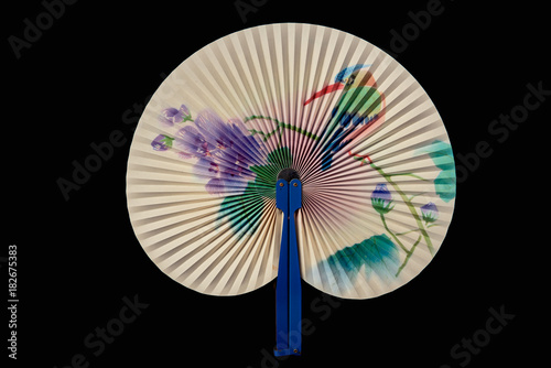 Closeup of Traditional Chinese fan on black background.
