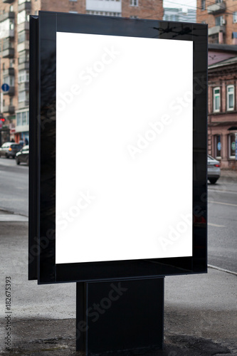 Blank mock up of vertical street poster billboard on city background