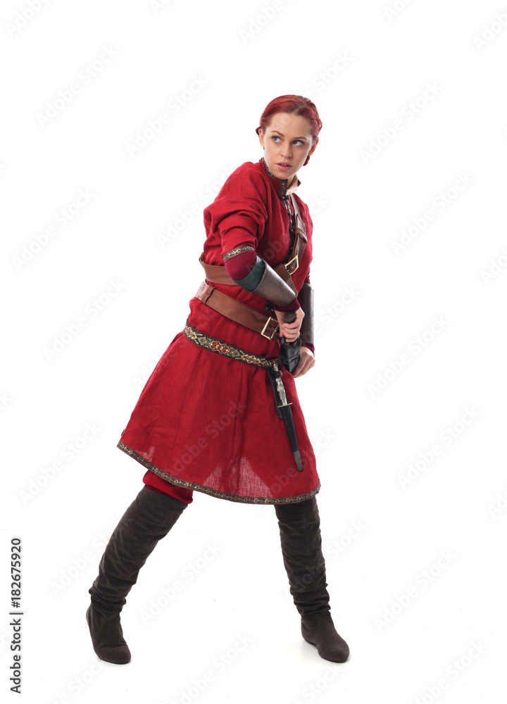portrait of a red haired girl wearing medieval warrior outfit, studio background. portrait of a red haired girl wearing medieval warrior outfit, studio background.