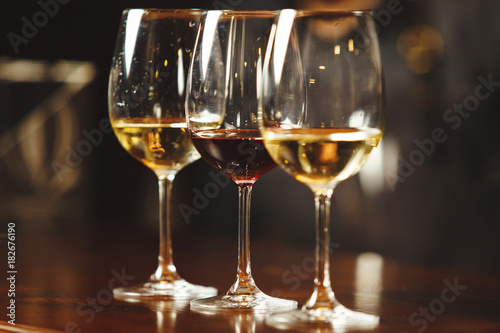 Glasses of white and red wine on bar counter