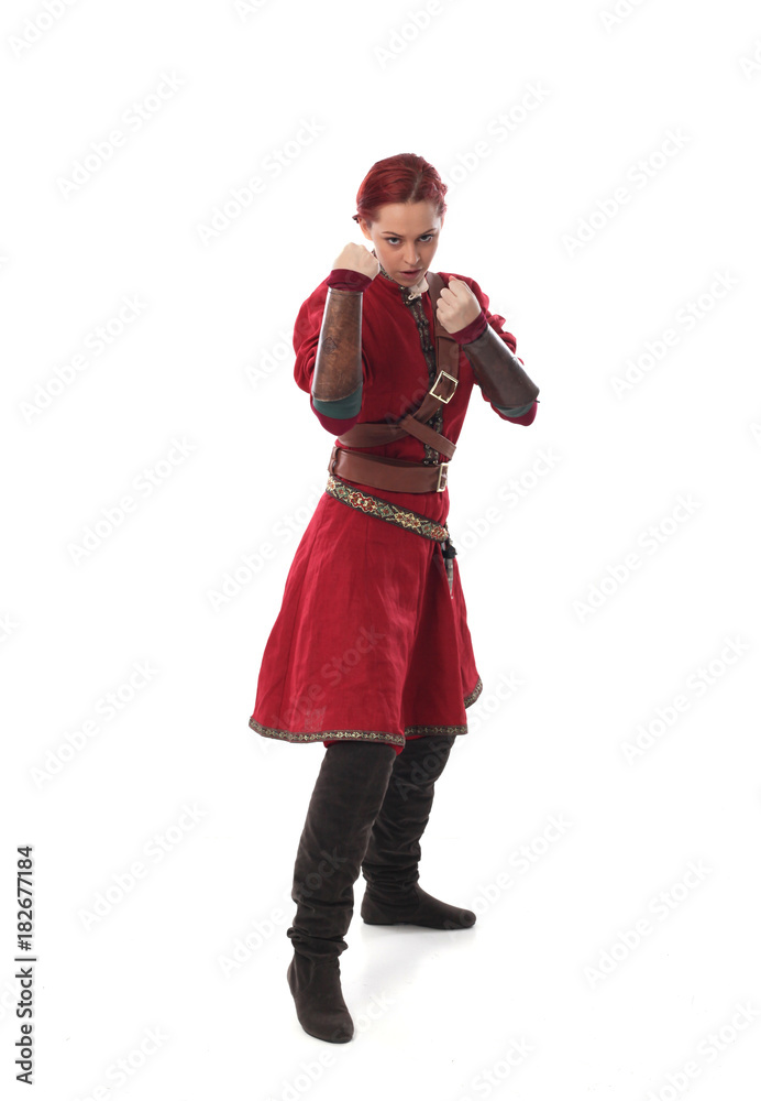portrait of a red haired girl wearing medieval warrior outfit, studio background. portrait of a red haired girl wearing medieval warrior outfit, studio background.