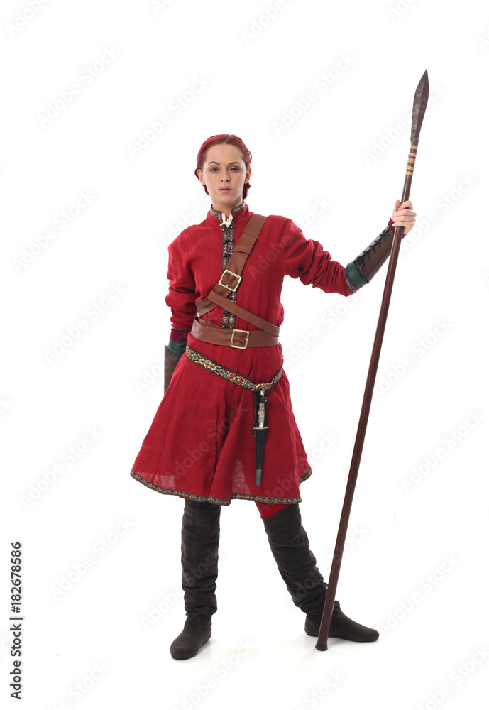 portrait of a red haired girl wearing medieval warrior outfit, studio background. portrait of a red haired girl wearing medieval warrior outfit, studio background.