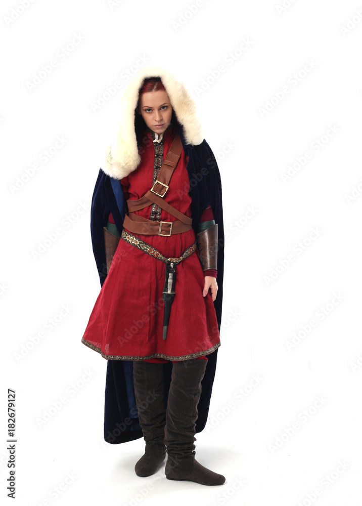 portrait of a red haired girl wearing medieval warrior outfit, studio background. portrait of a red haired girl wearing medieval warrior outfit, studio background.
