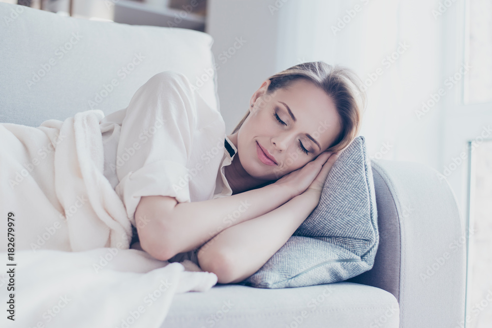 Close up portrait of relaxed dreamy happy beautiful pretty woman having a day nap, she is sleeping in a living room Close up portrait of relaxed dreamy happy beautiful pretty woman having a day nap, she is sleeping in a living room
