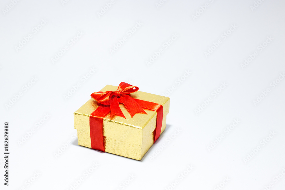 Gloden gift box with red bow on white background Gloden gift box with red bow on white background
