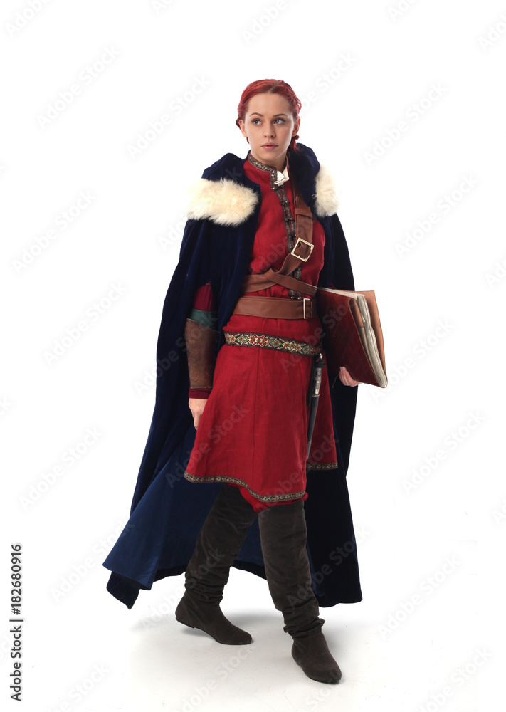 portrait of a red haired girl wearing medieval warrior outfit, studio background.