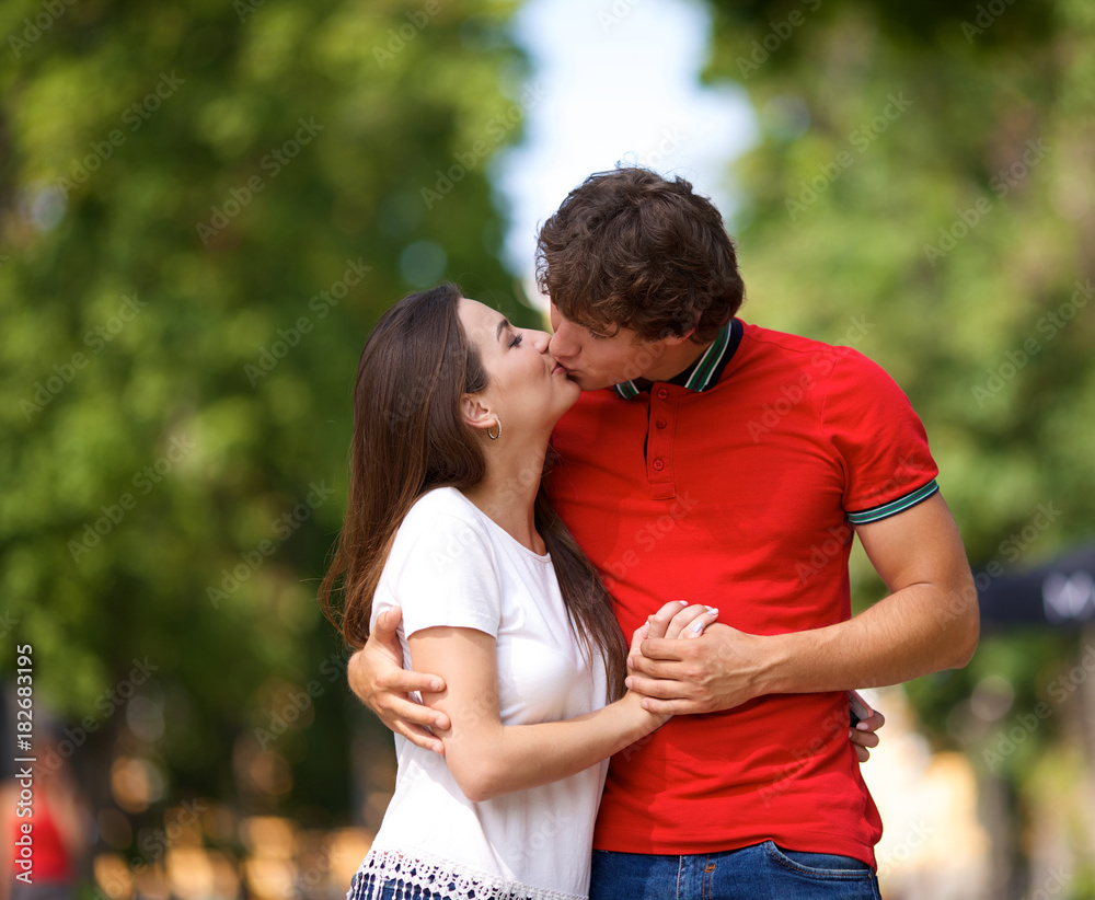 young couple kissing in the park.