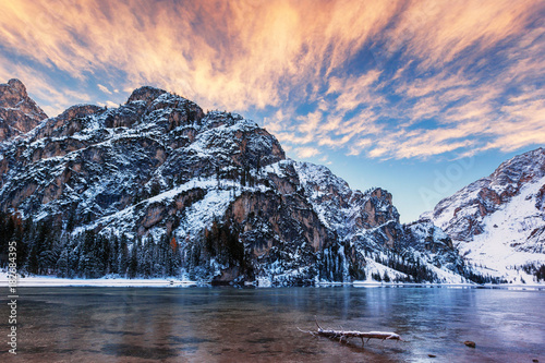 winter sunrise with colorful cloudscape over Lago di Braies, Dolomites, Italy