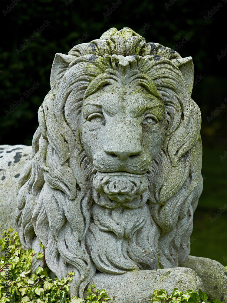Classical head of a majestic lion in stone