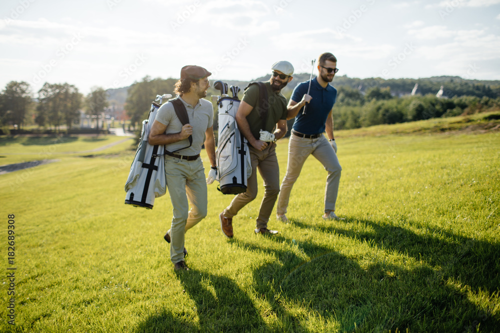 Golf player walking and carrying bag on course during summer game golfing Golf player walking and carrying bag on course during summer game golfing