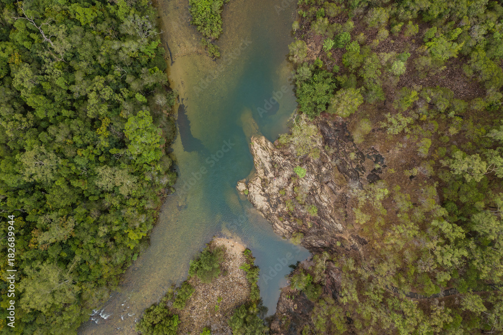 Aerial view of a rainforest swimming hole.