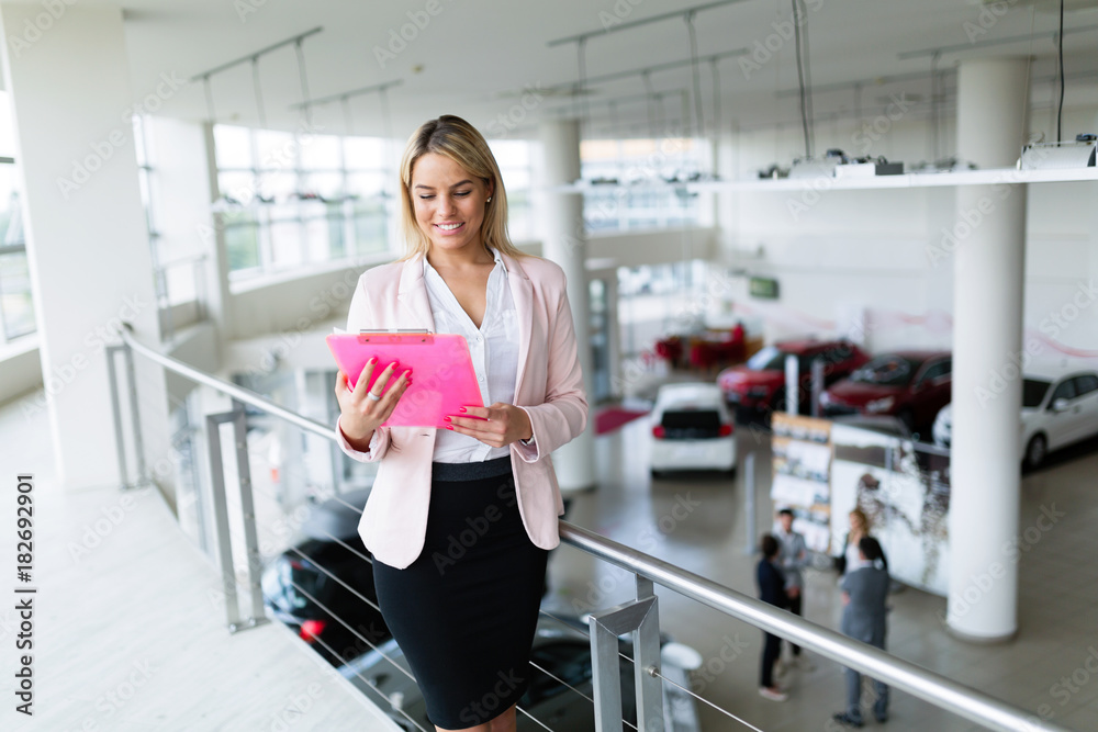 Picture of professional salesperson working in car dealership Picture of professional salesperson working in car dealership