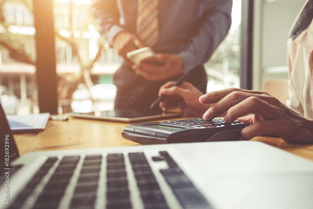 Businessman working with calculator. Business people meeting at working with financial reports Businessman working with calculator. Business people meeting at working with financial reports