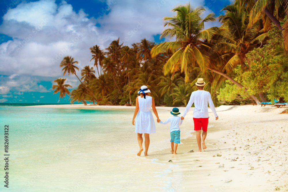 family with child walking on beach