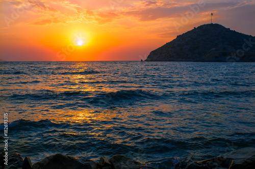 Dramatic orange sunset over the Turkish beach of Gumusluk