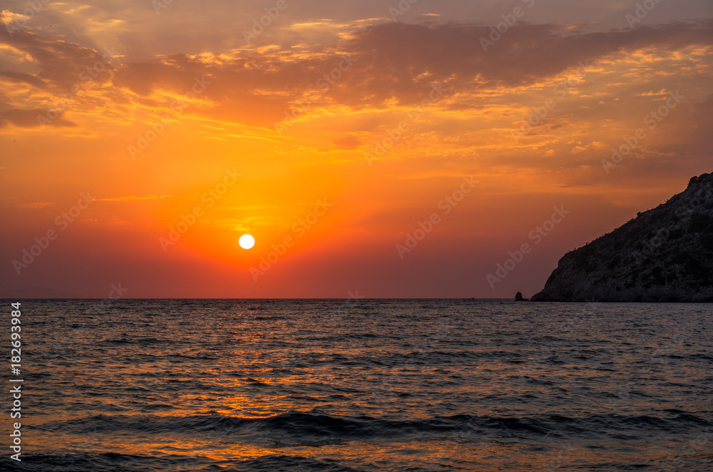 Dramatic sunset over the Aegean sea, Gumusluk, Turkey