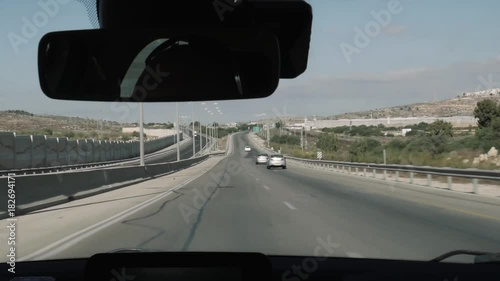 View from moving car on israeli road, in the side separating wall.