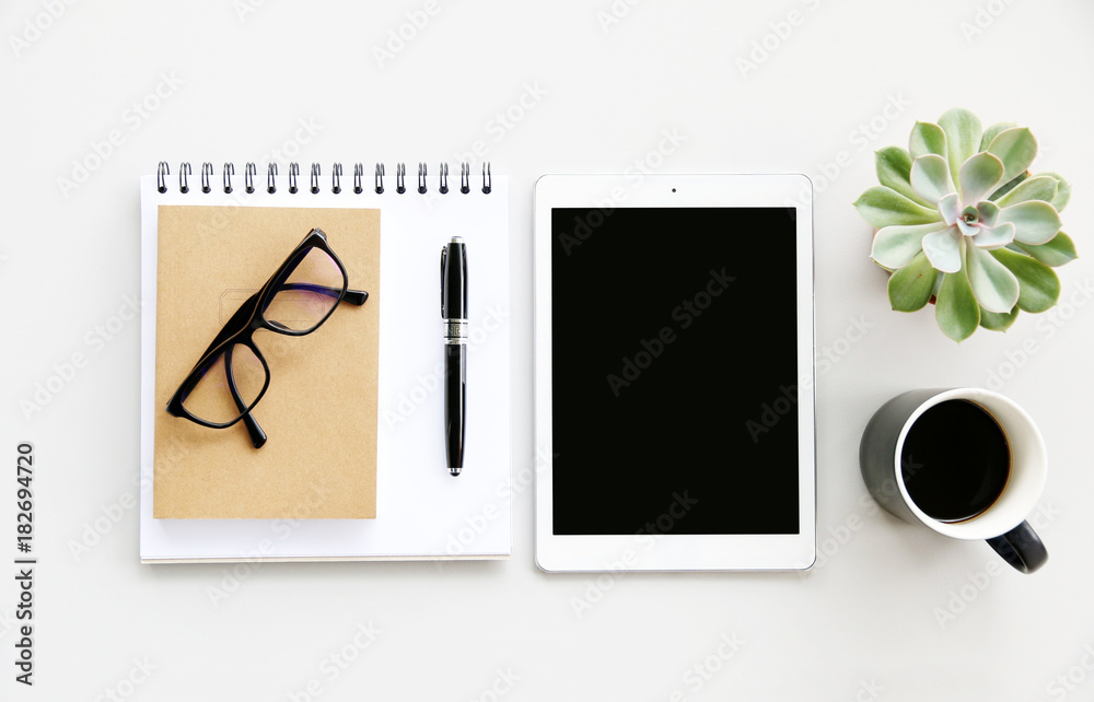 Naklejka premium Office table with glasses,notebook,Coffee,pen and cactus, copy space,Top view, flat lay
