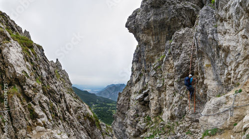 Woman climbing a ladder on the Via Ferrata at the Grigna Settentrionale (2408 m, Grignetta), Lake Como, Italy photo