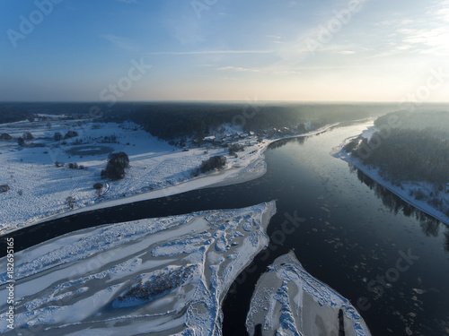 Aerial view over river Nemunas and Merkys connection in small town Merkine, Lithuania. Aerial photography during winter season. photo