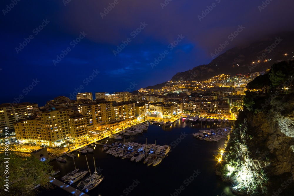 Panoramic view of Port de Fontvieille at night in Monaco. Azur coast. Luxury yachts